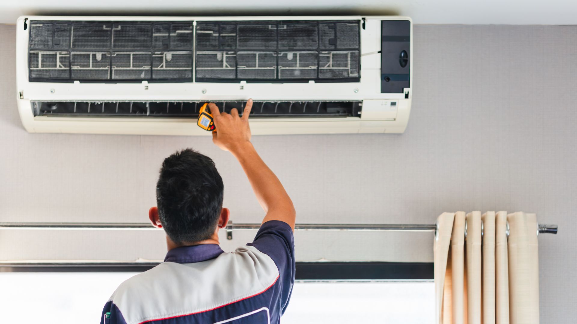 technik naprawia klimatyzację